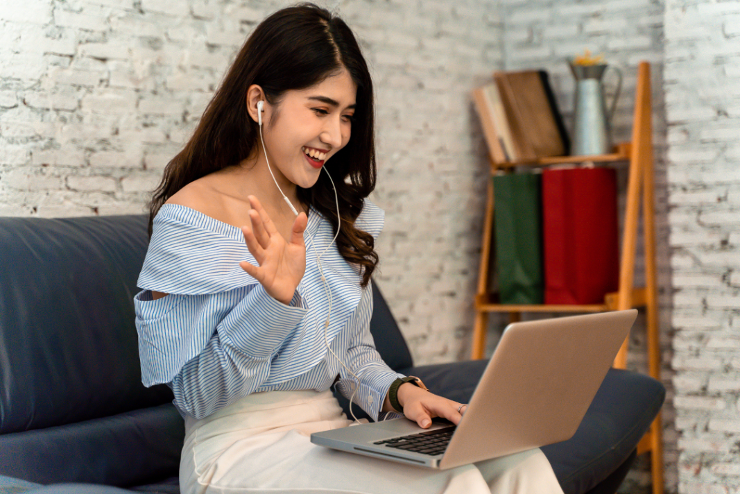 Filipina candidate waving hello during a remote interview