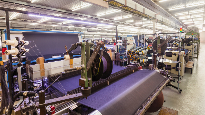 A fabric factory with lots of machines and sewing machines