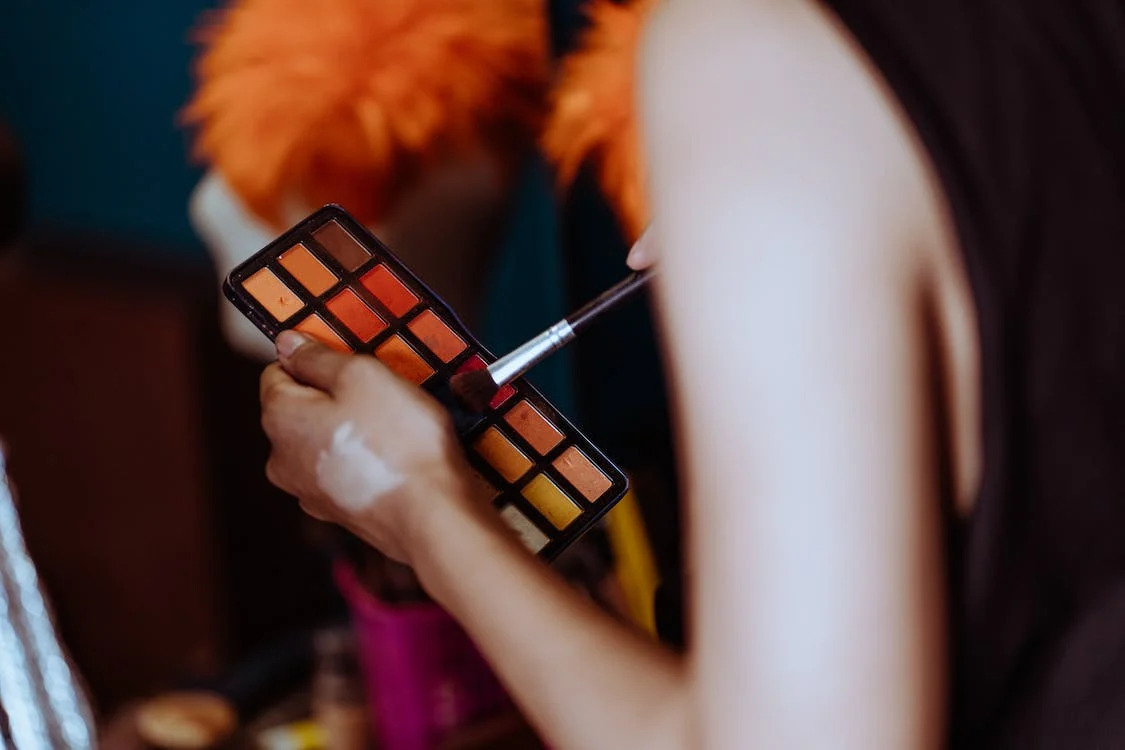 woman holding an eyeshadow palette