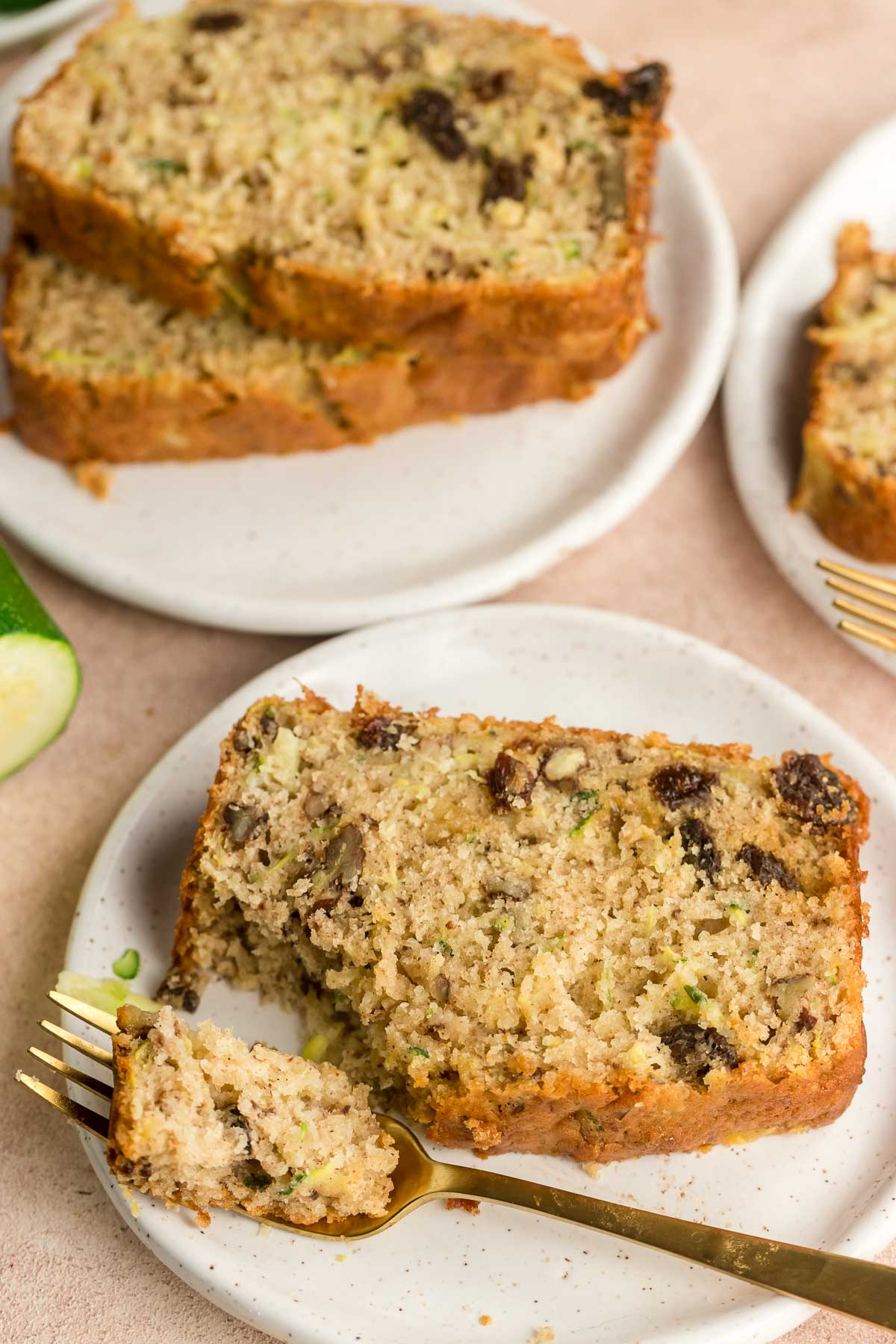 slice of zucchini bread on a plate with a fork