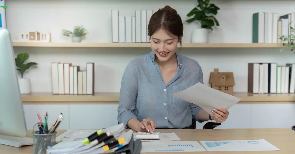 Woman organizing documents for tax filing.