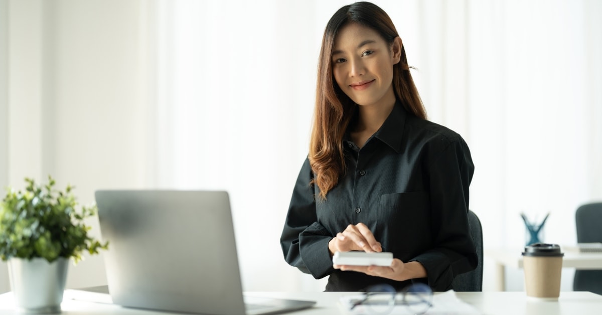 A professional tax accountant calculating costs using a calculator, essential for managing tax accountant costs.