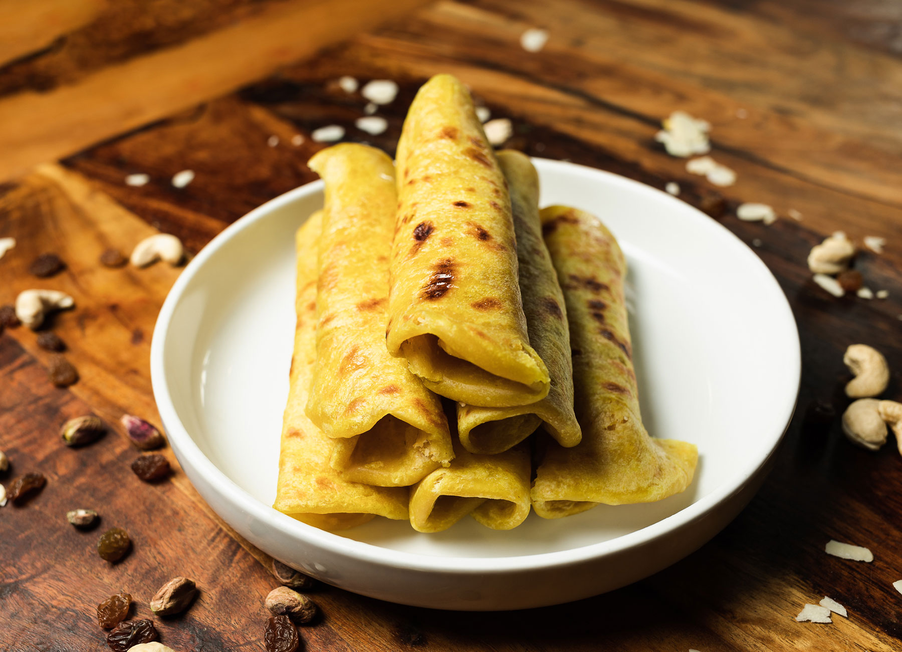 Puran Polli, a traditional sweet dish, showcasing layers of delicately prepared ingredients and rich textures.