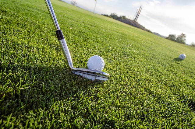 A golfer performing a chip shot with a golf club