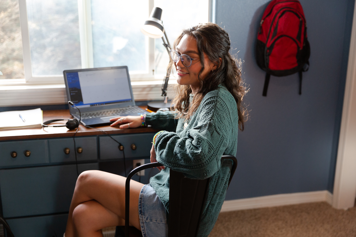 A well-organized study space in a dorm room with essential desk supplies.