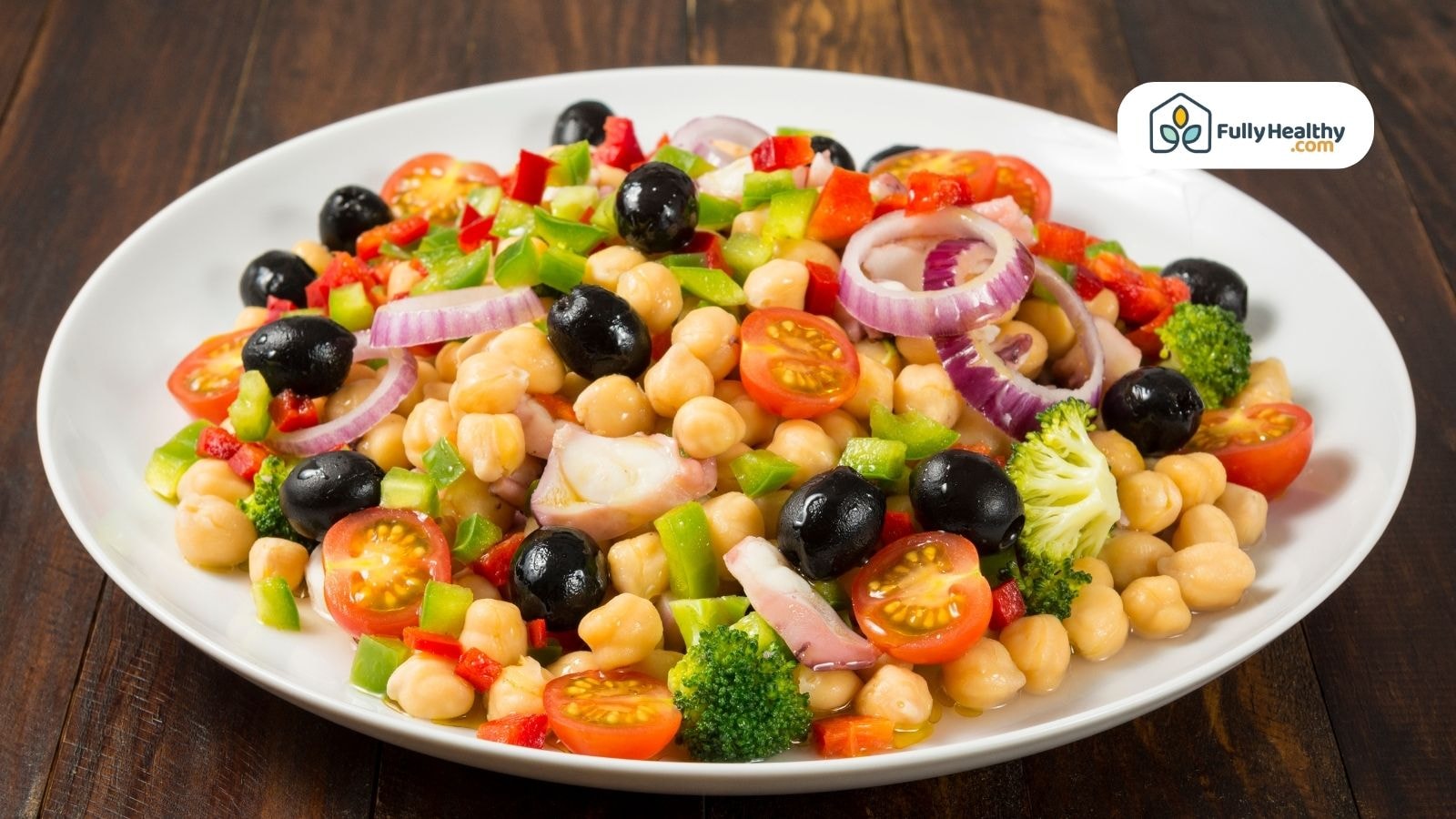 Colorful chickpea salad with vegetables and black olives