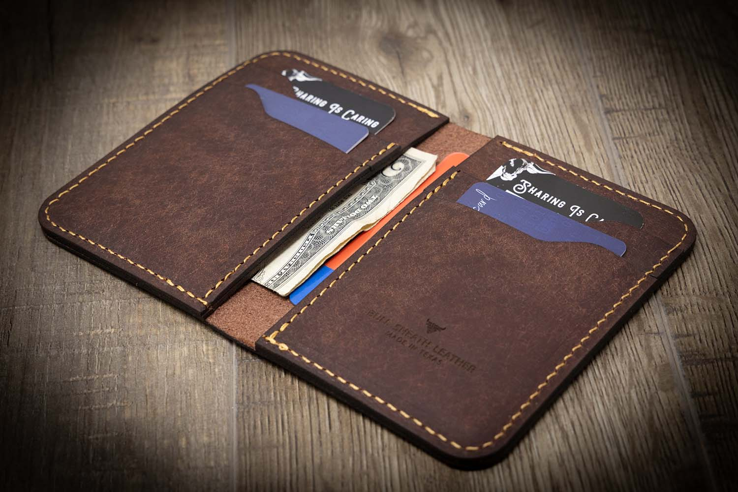 A man holding a card holder wallet with unique features