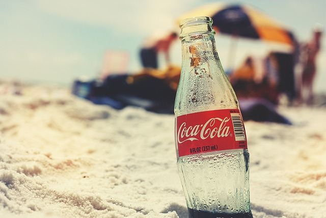 coca cola bottle on the beach symbolizing how repeat ordered product sales drives business