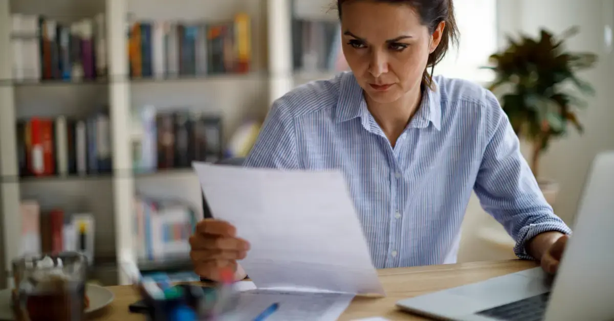 Woman reviewing Form 4506-T documents for OnlyFans income verification and tax records
