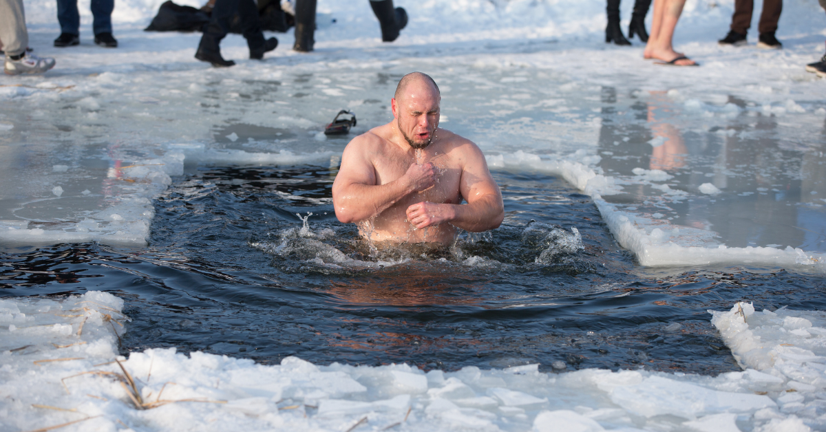 A person taking an ice bath in very cold water for health benefits, better blood flow, and a better immune system.