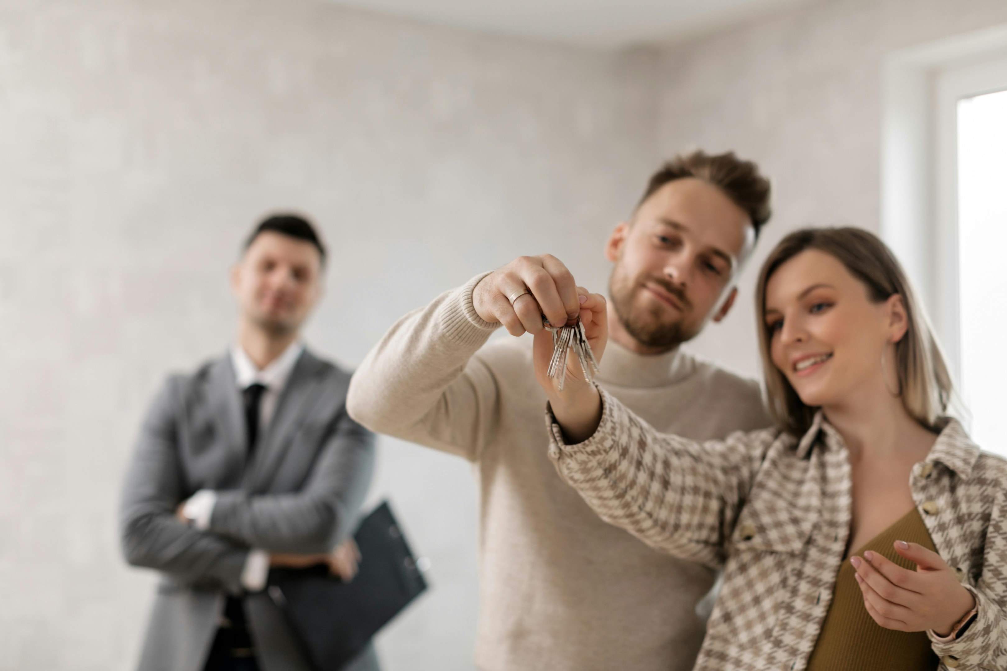 Satisfied tenants hold keys to their new rental.