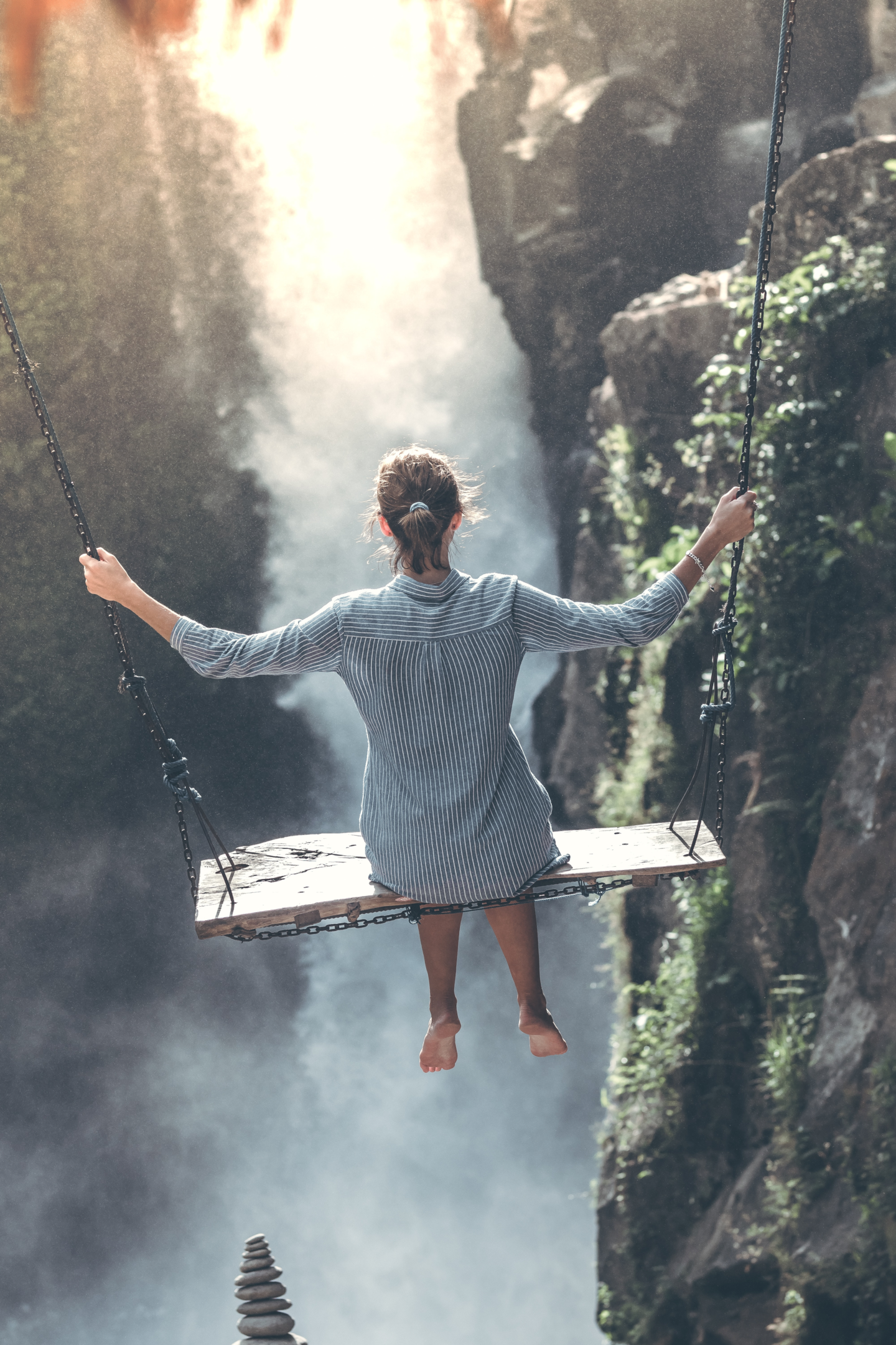 woman on a swing looking over a valley 
