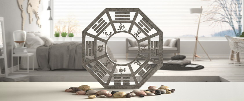 A hexagonal stone piece showing the feng shui bagua.