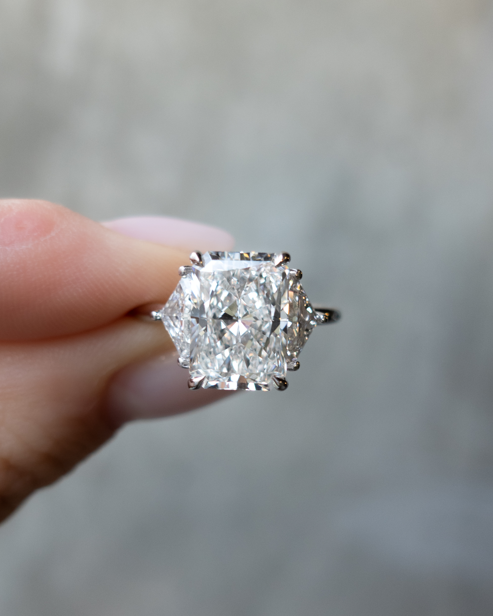 A Three Stone Engagement ring with Shield sides and a 4 carat Radiant Cut diamond