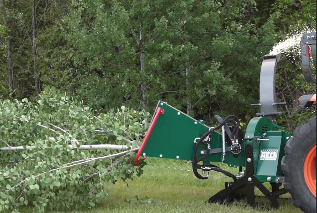 A Woodland Mills TF810 PRO chipping an entire tree in the feed chute.