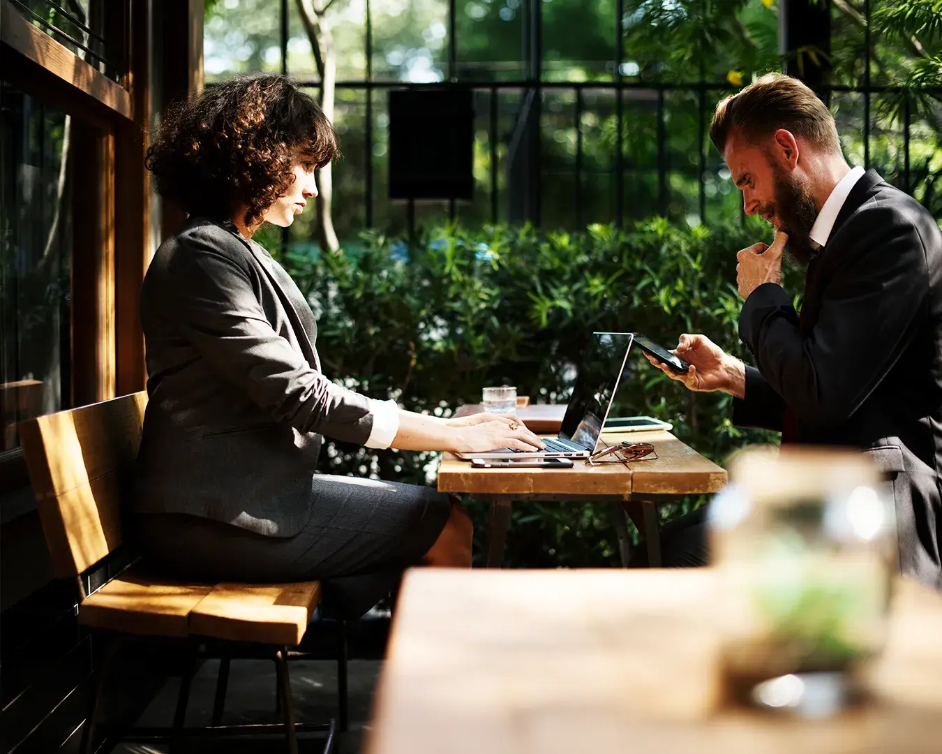 Restaurant owners reviewing QR code menu ordering strategy and digital restaurant operations during a hospitality business meeting.