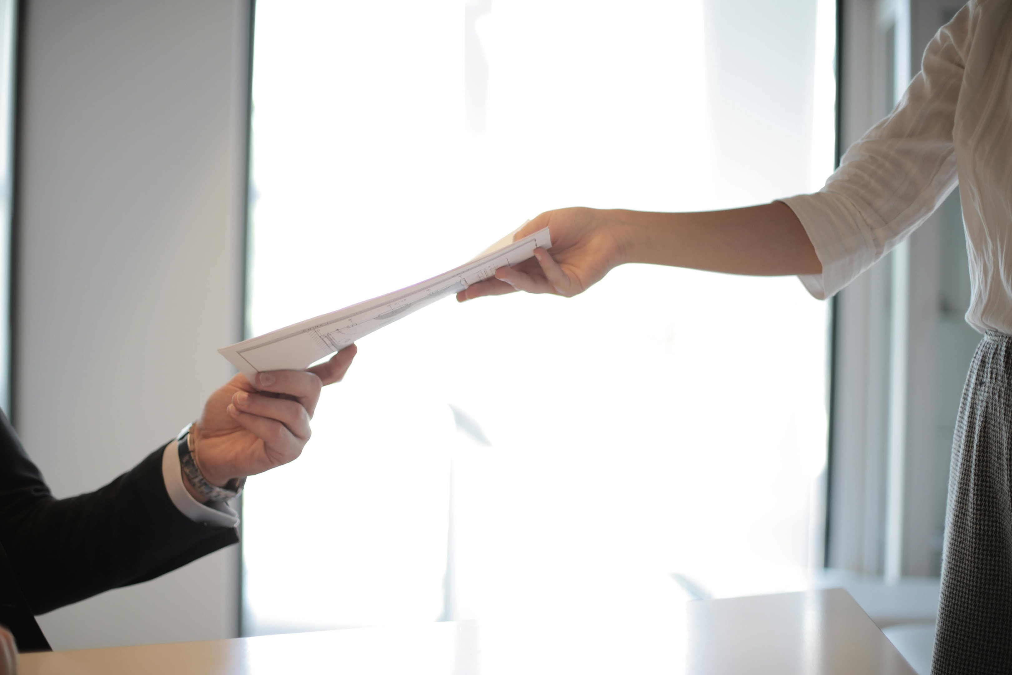 Public records documents being passed to real estate investor.