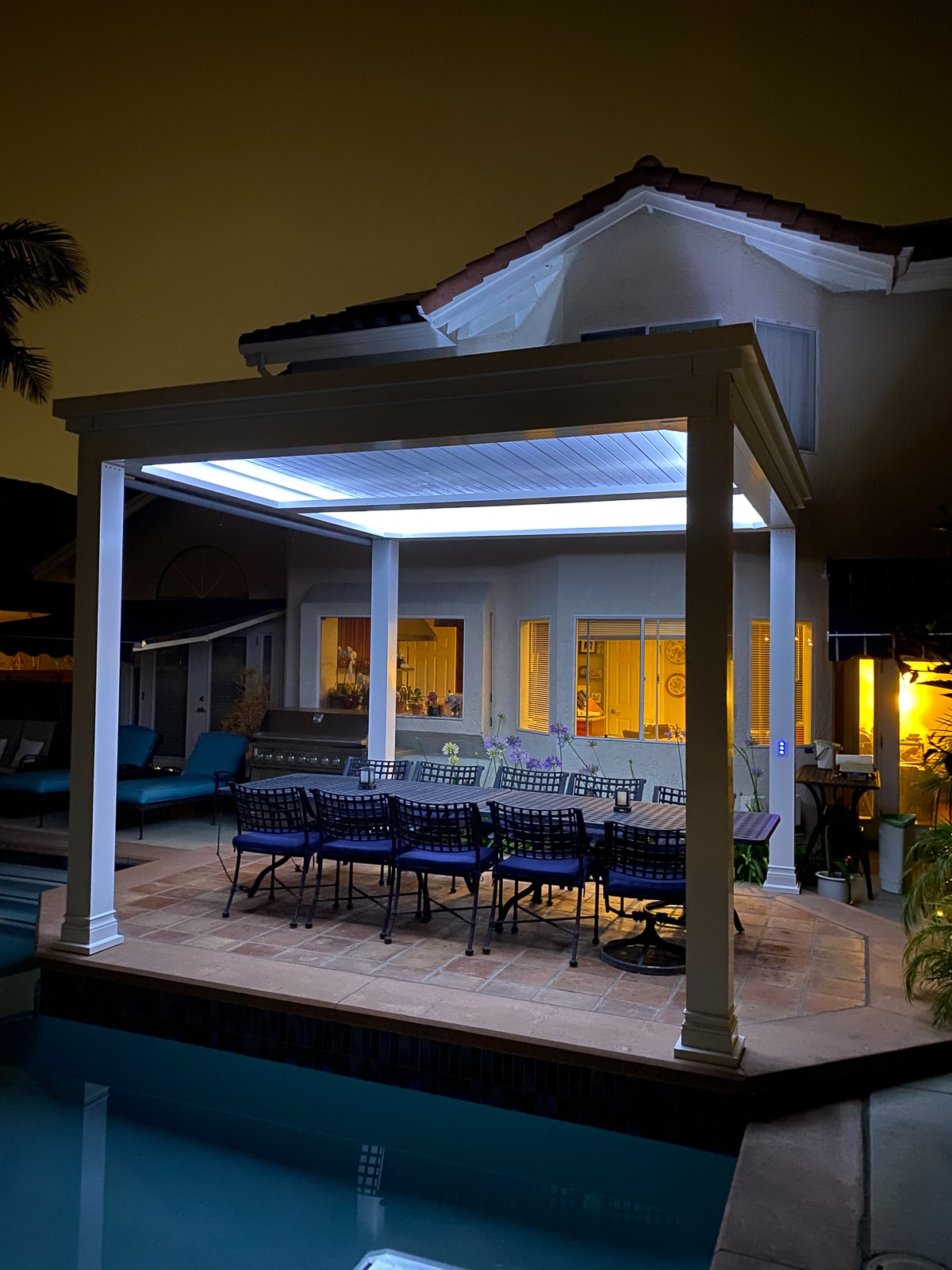 Poolside pergola is usable at night thanks to it's outdoor lighting.