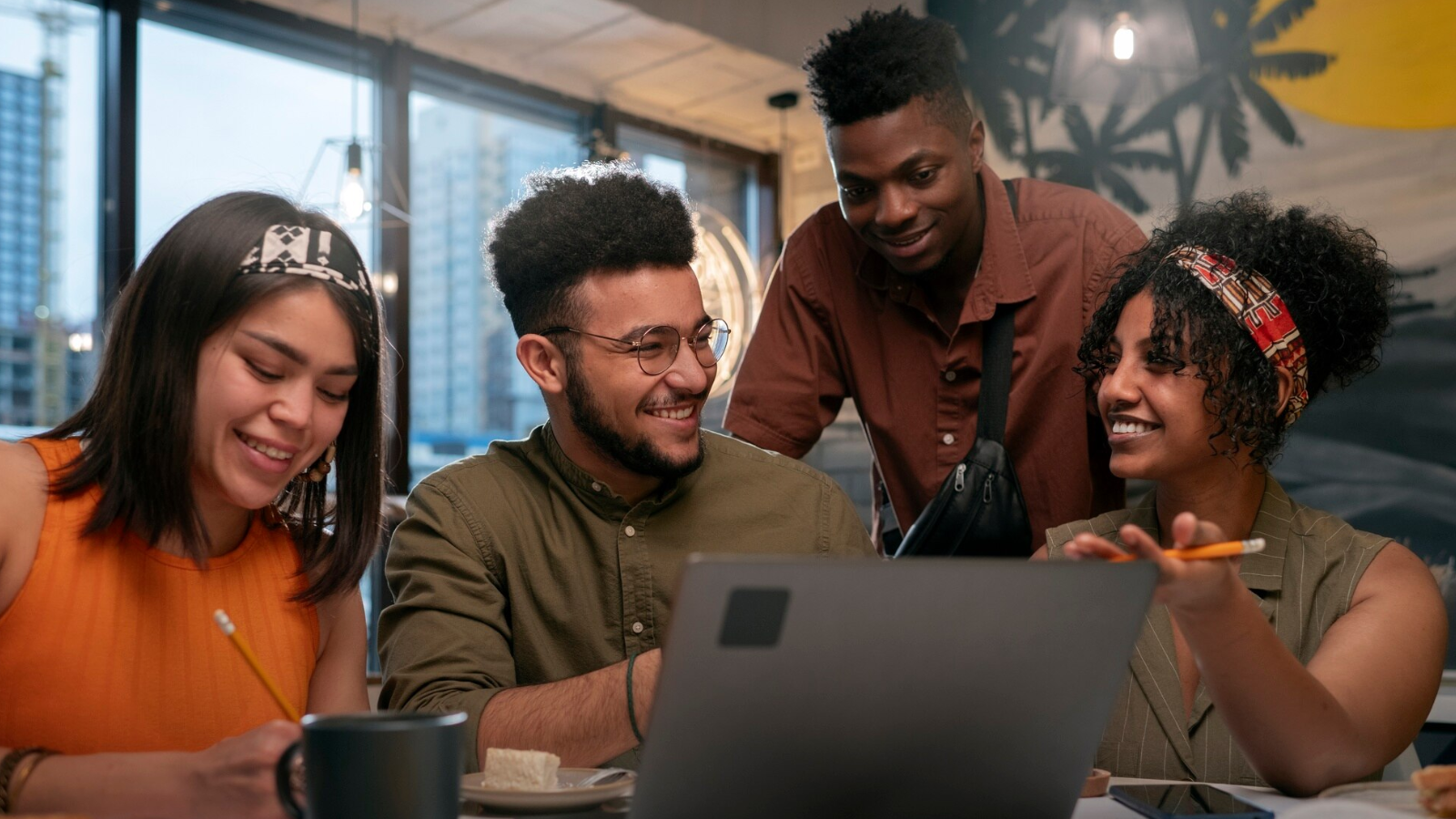 How Teams Chat and Slack Integration Enables Cross-Platform Messaging 4 A team gathered around a laptop, smiling and working together—bringing project management to life through chat tools.