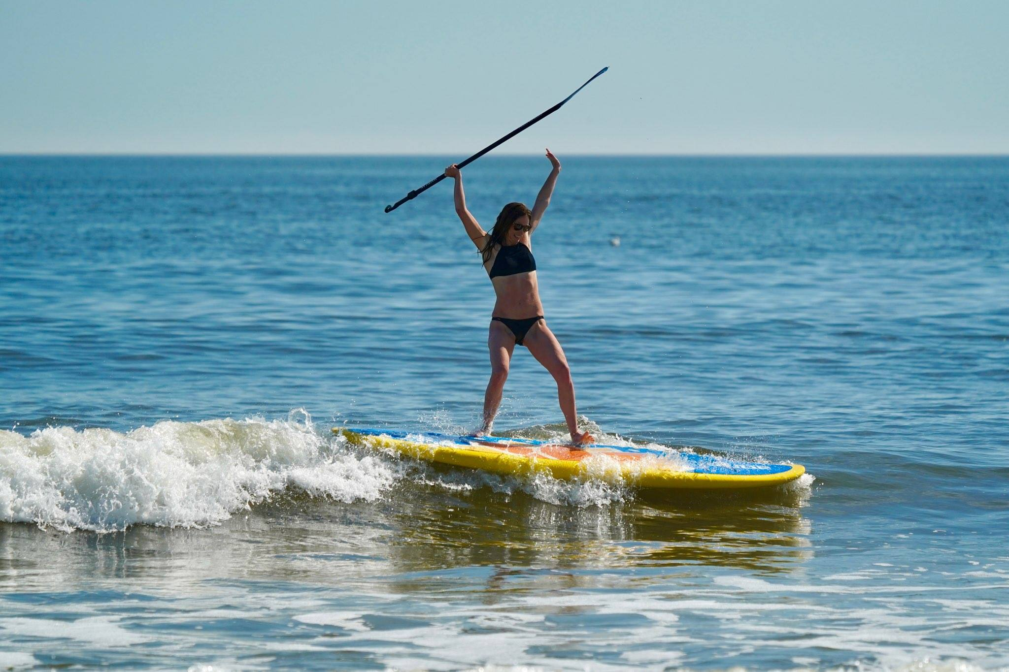 surfing waves on a paddle board