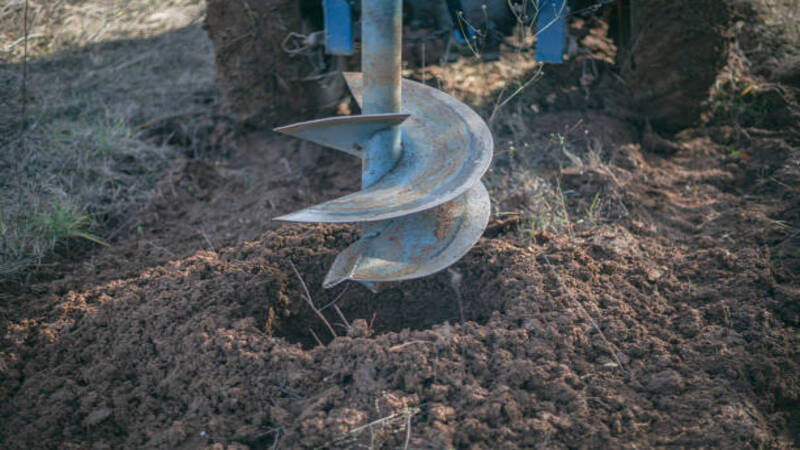 An auger making hole in the ground. 