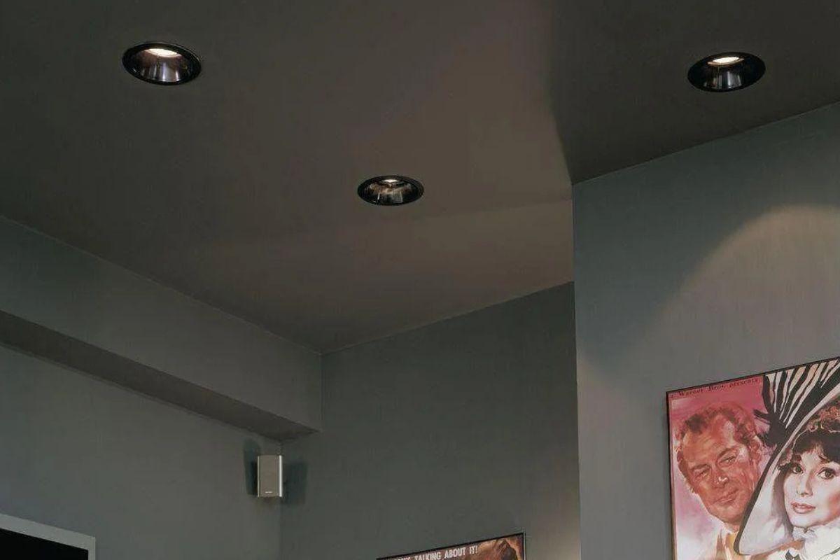 Black recessed light fixtures installed in a dark ceiling to provide focused direct light