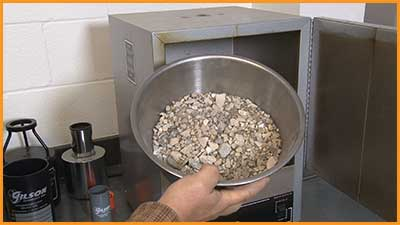 A picture of a mechanical splitter and a pile of aggregates