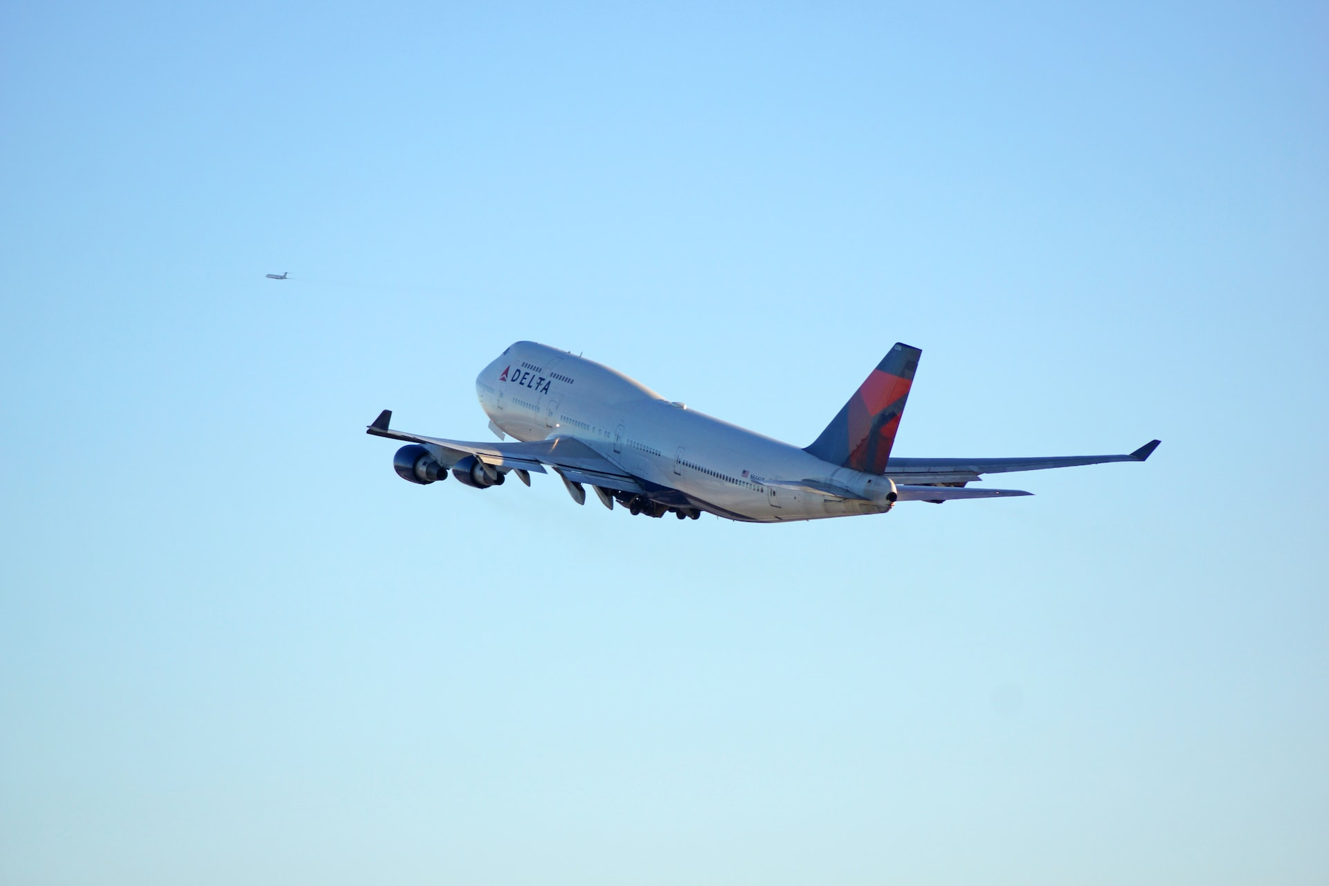 A Boeing 747 aircraft taking off into a clear sky.