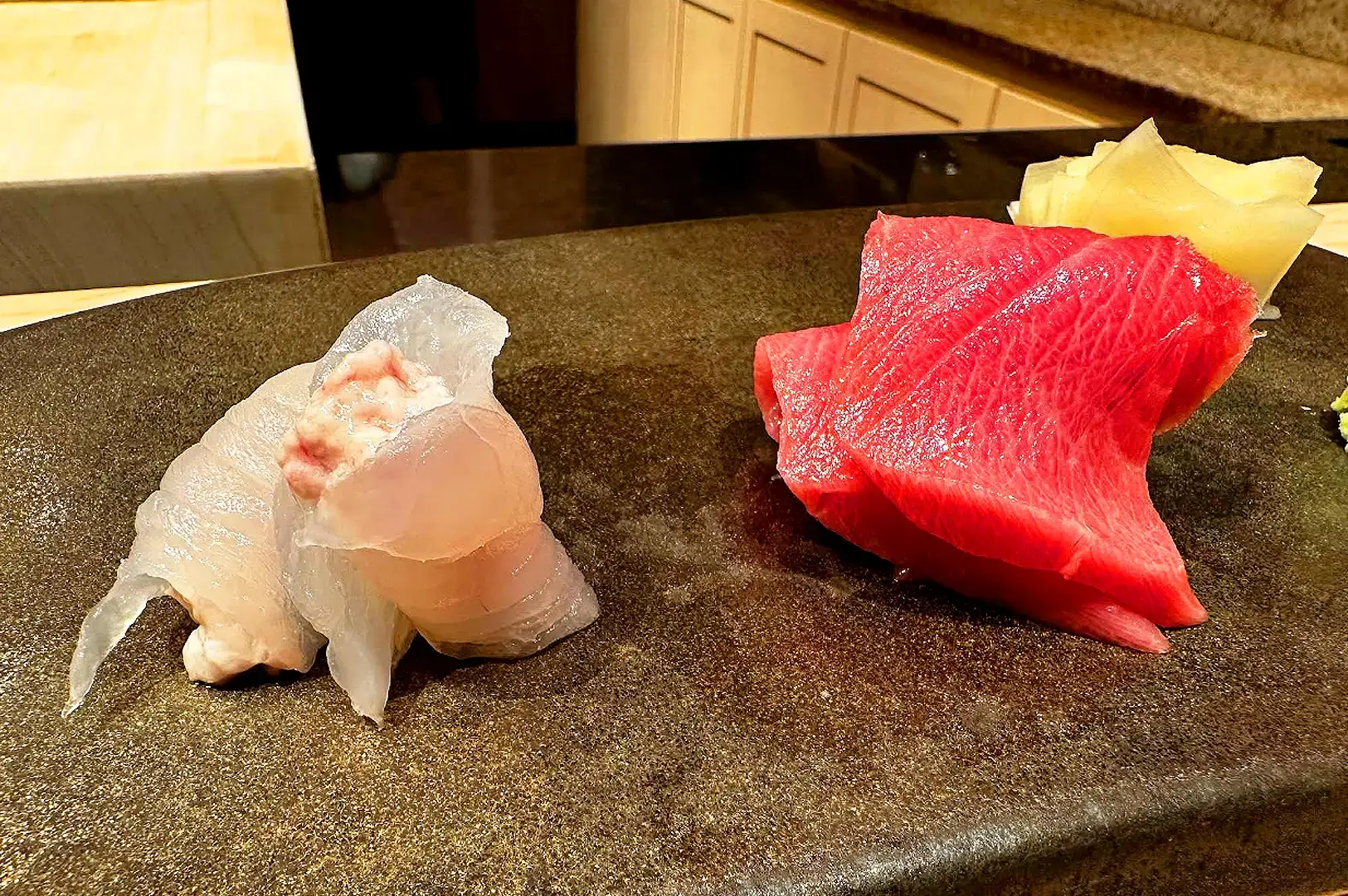 Premium omakase sashimi in Singapore featuring fresh white fish and fatty tuna slices served with pickled ginger and wasabi