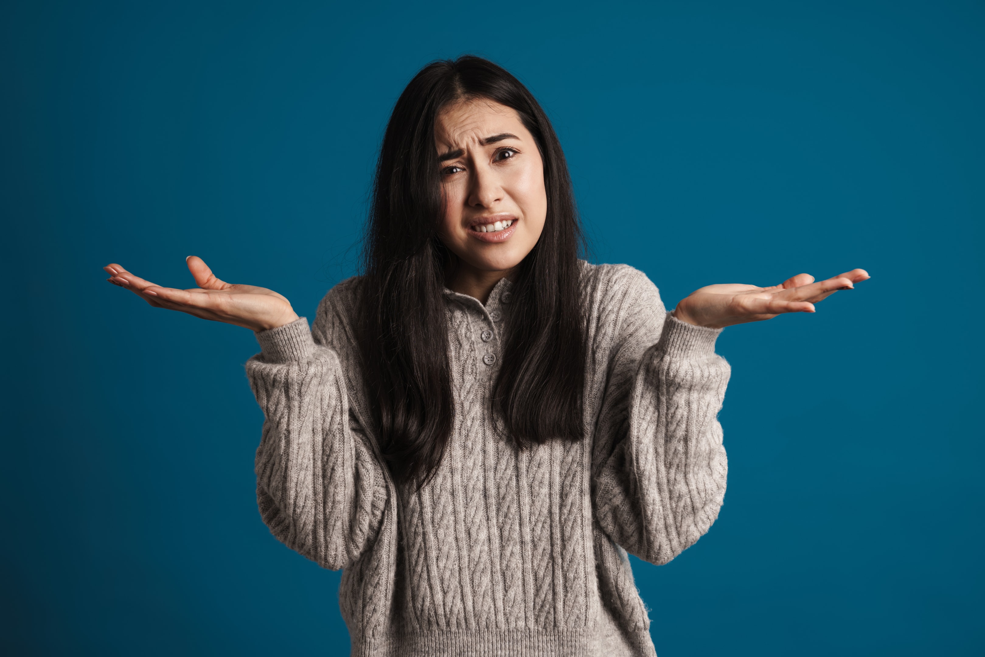 Woman wondering when you should get your wisdom teeth removed