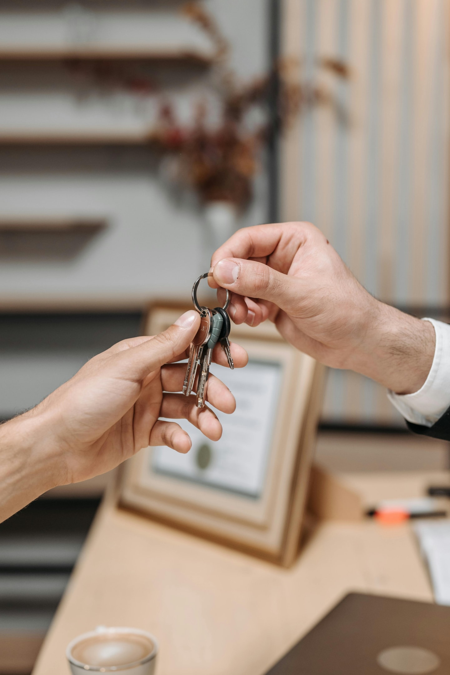 House keys being passed after a successful virtual wholesale deal.