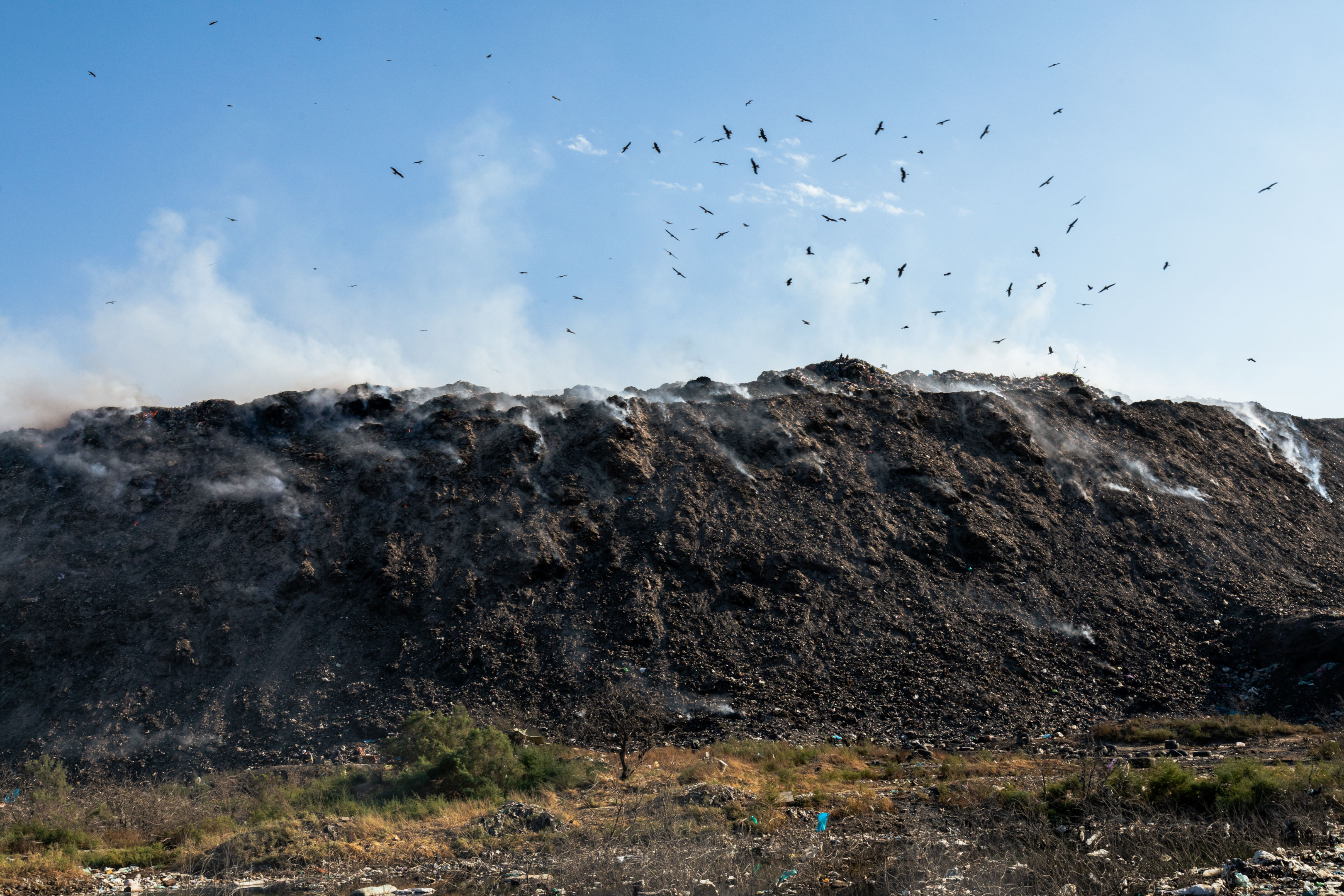 Methane generation from burning organic material in landfill