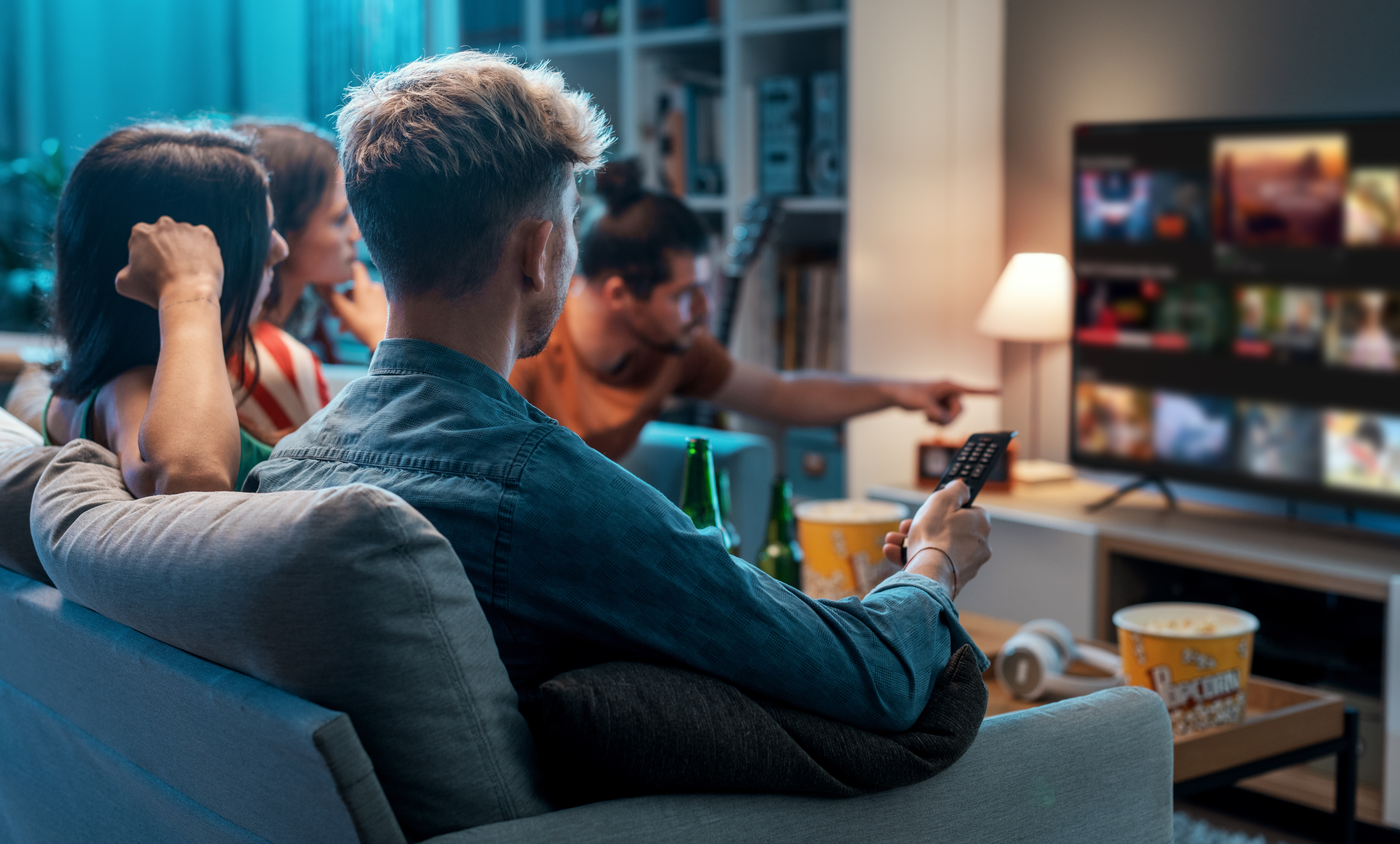 A group of friends decide what to watch on the living room television