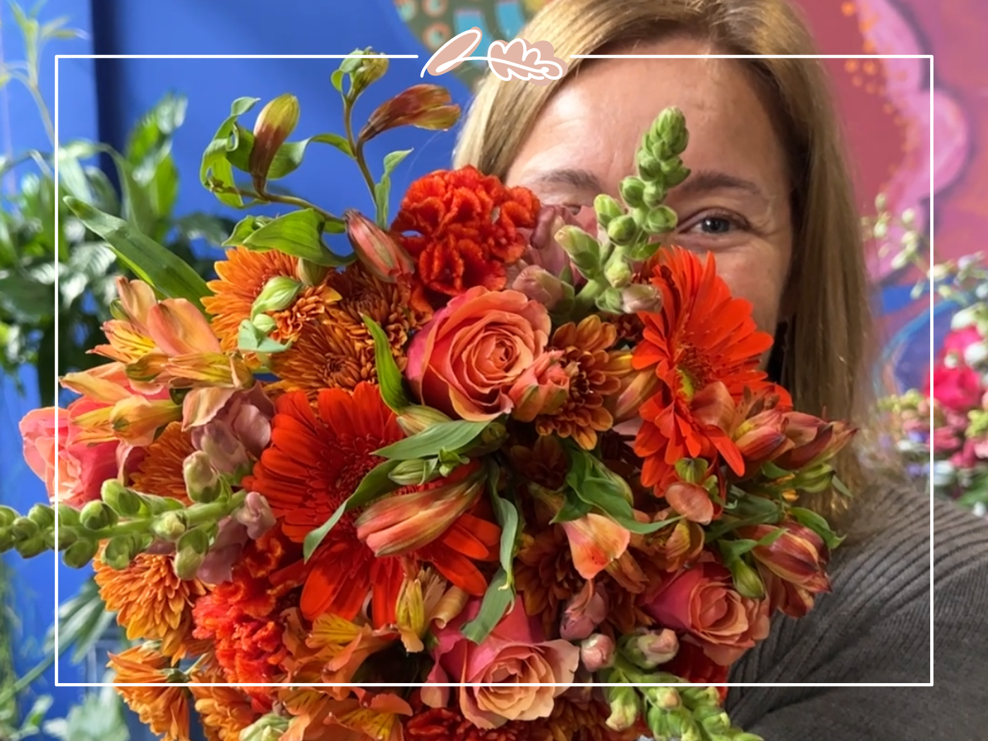 A woman holding a vibrant bouquet of fresh orange flowers at Bunches for Africa, showcasing the beauty of their Cape Town store. Perfect for weddings, functions, and celebrations. Find this and more at Fabulous Flowers and Gifts.