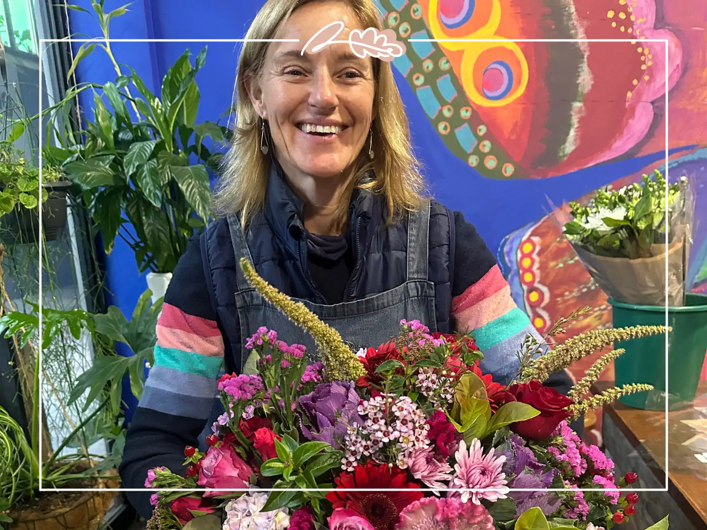 Smiling woman holding a colorful bouquet - Fabulous Flowers and Gifts