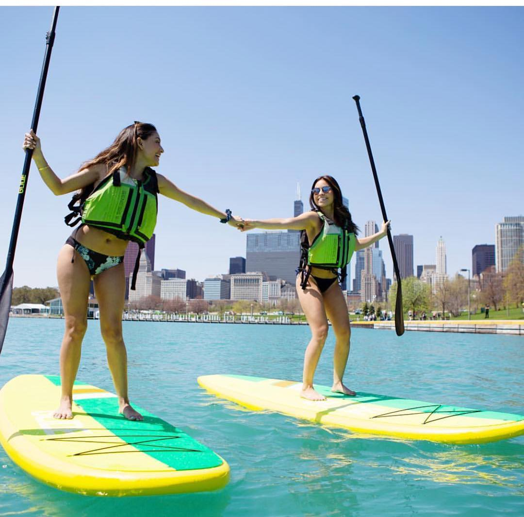 two girls paddle boarding