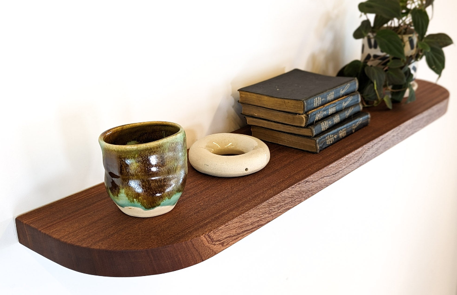A thick, large, genuine mahogany floating shelf with rounded corners 