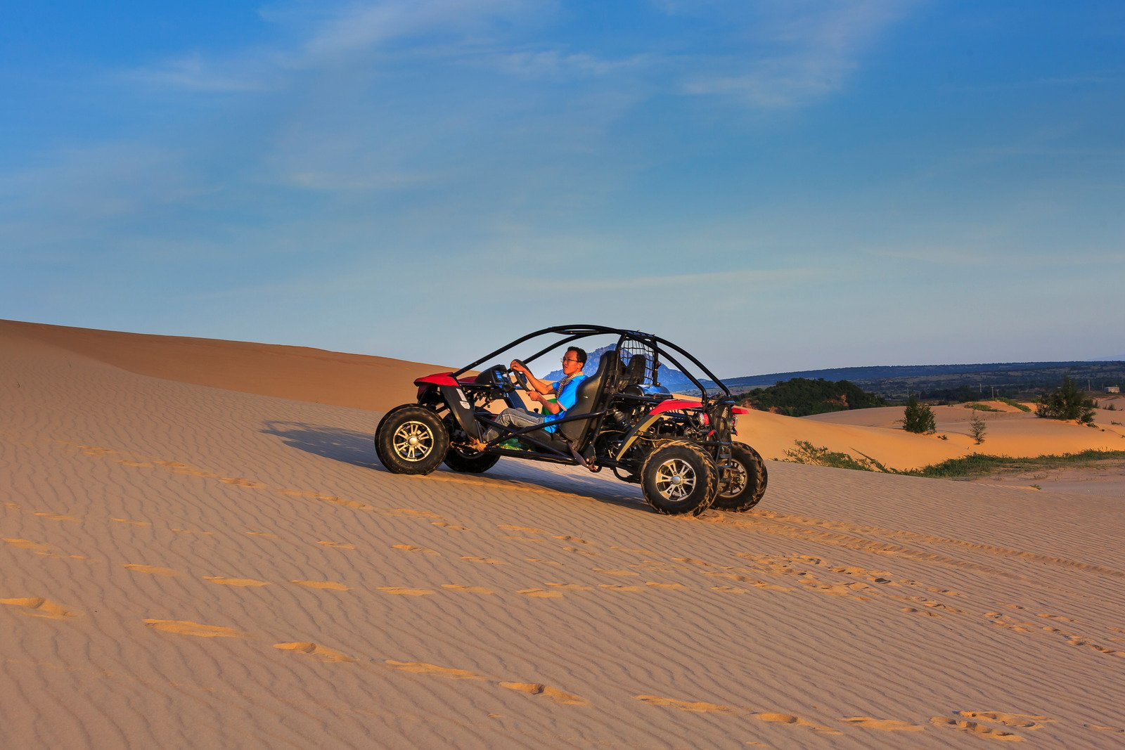 An ATV on sand dunes