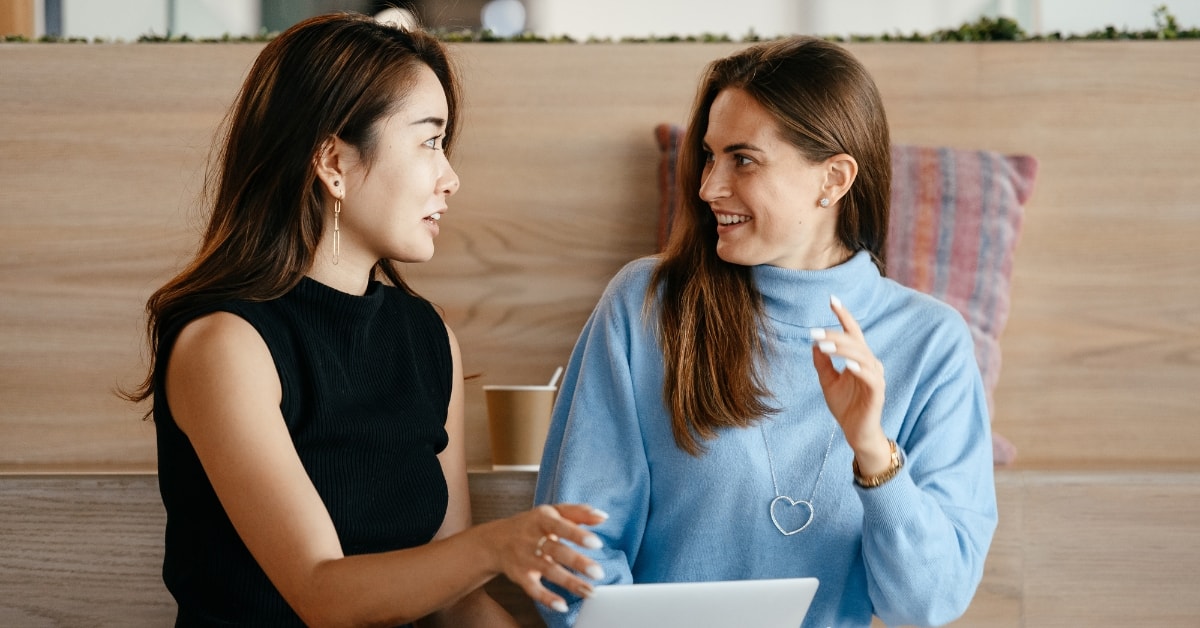 Two women engaging in a tax consultation, planning OnlyFans business taxes and deductions.