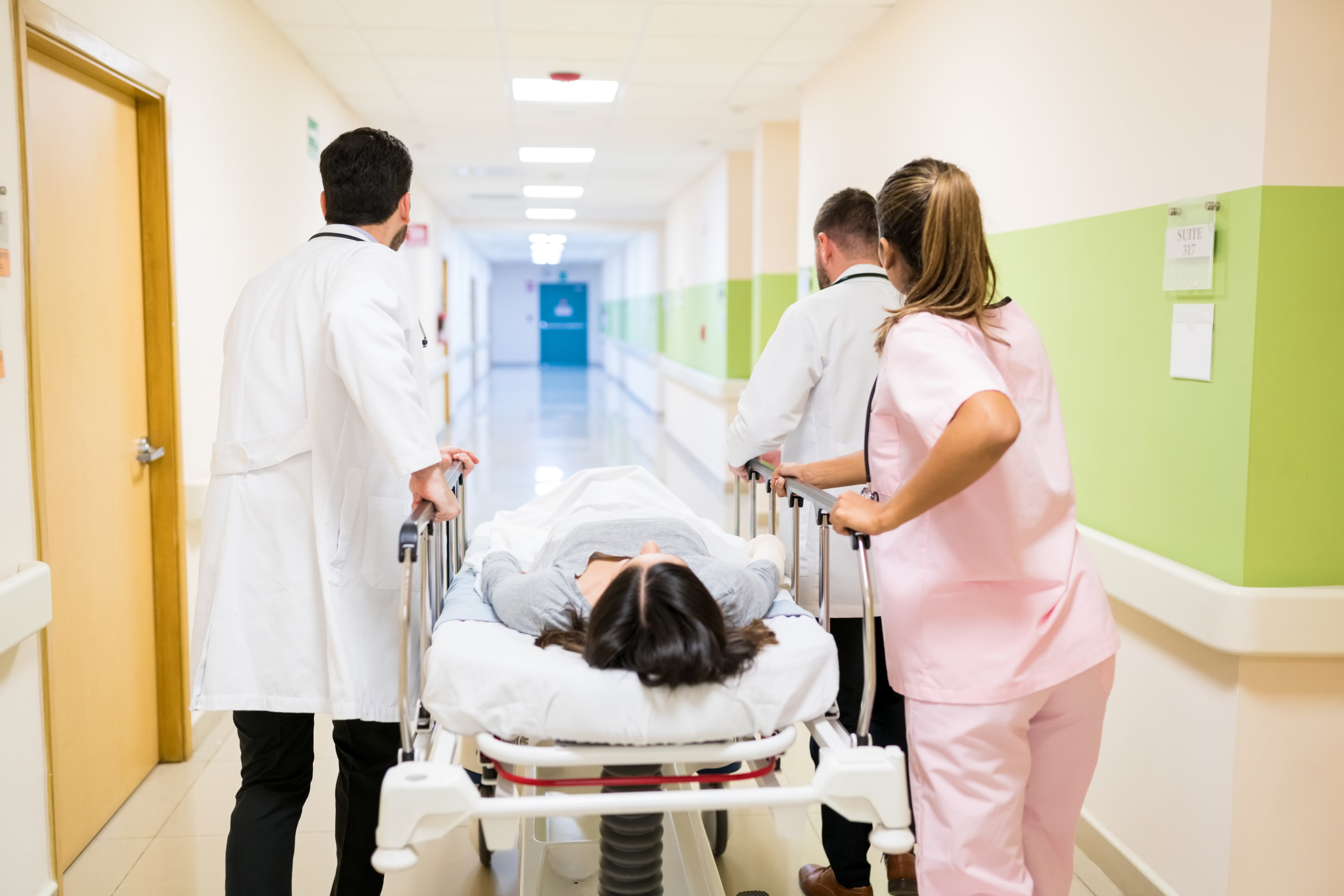 A stretcher being wheeled through a hospital corridor (Designed by Freepik)