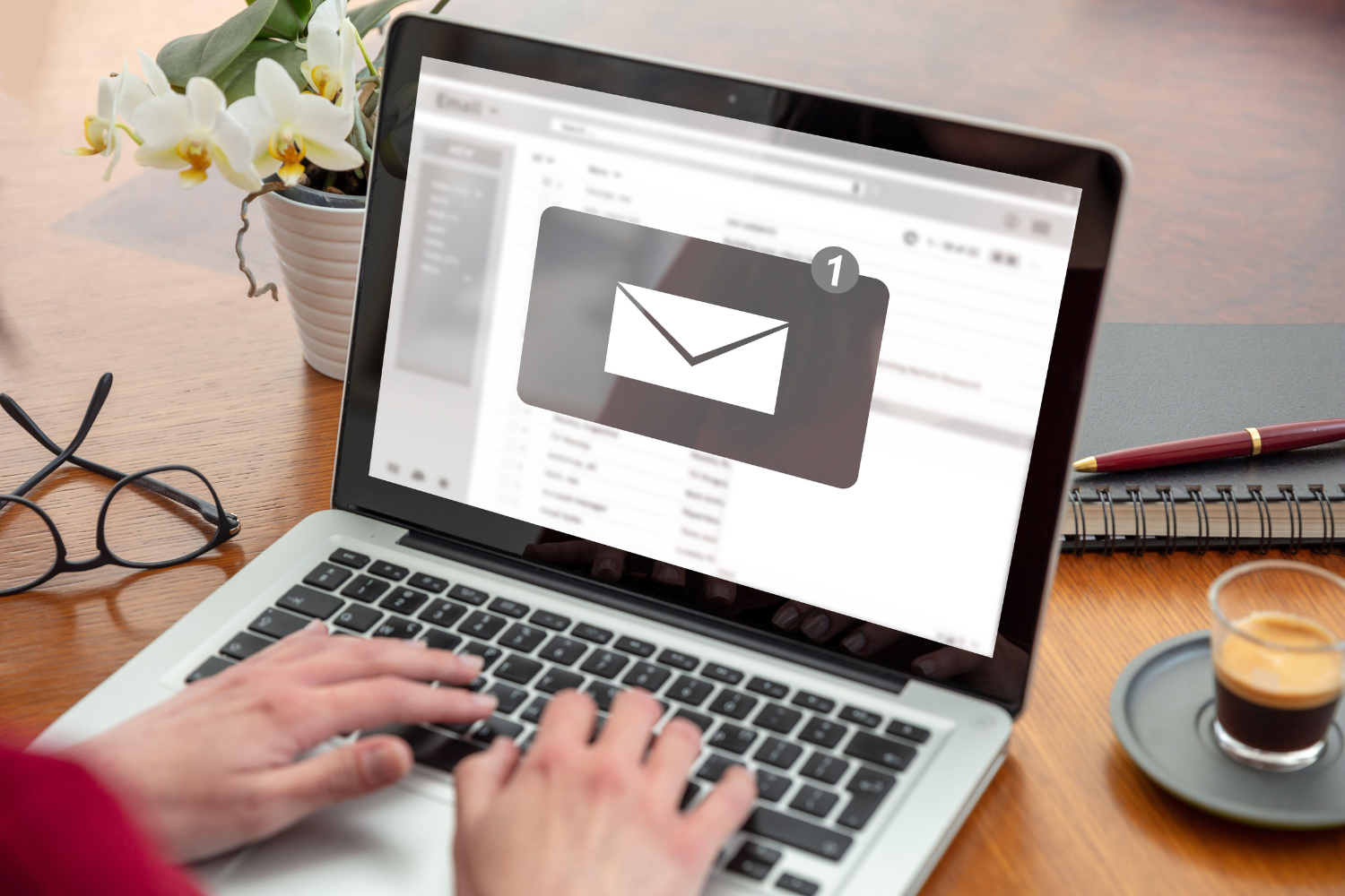 A laptop screen displaying a professional email icon.