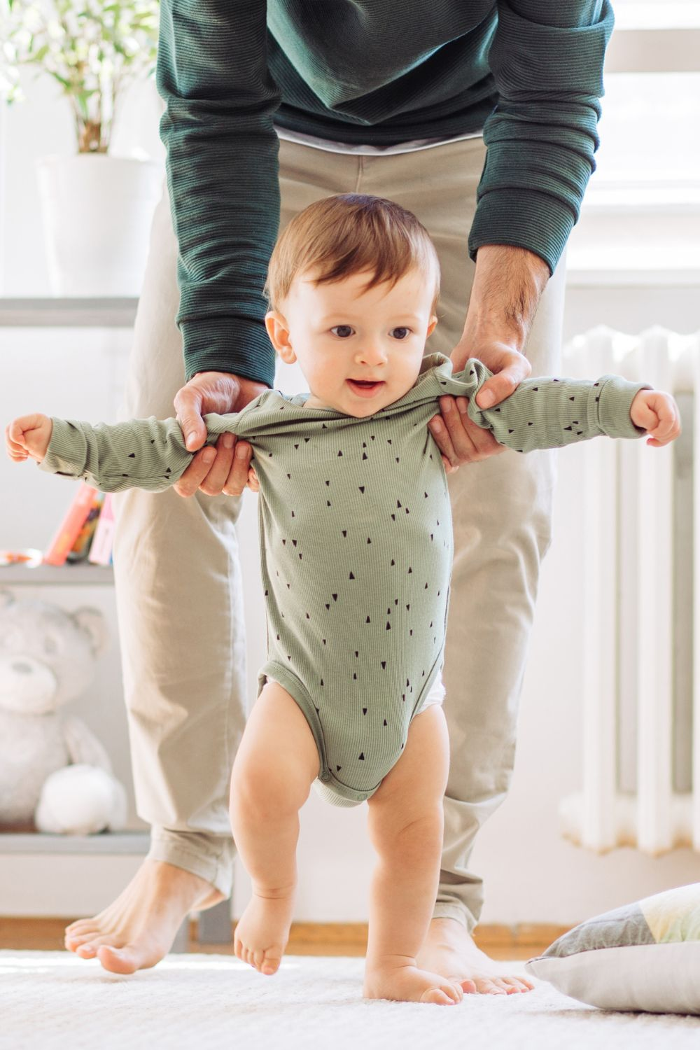 Baby Taking First Steps - Featured in What Are The Reasons For Delayed Walking In Babies
