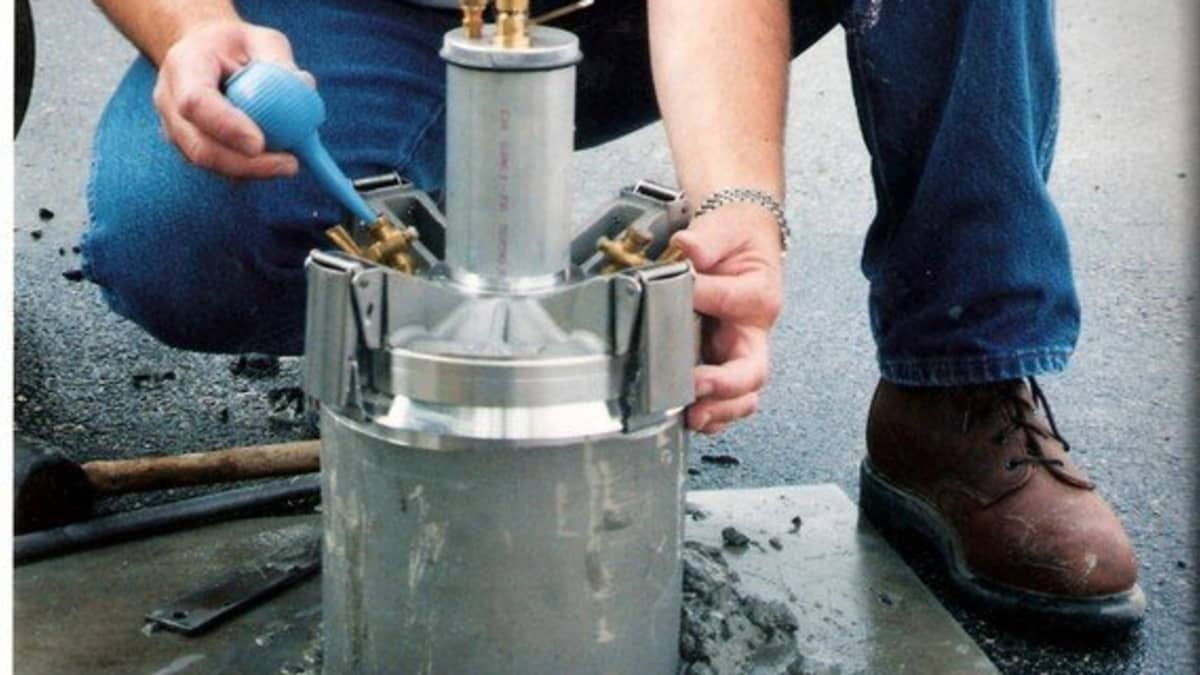 Concrete air meter being used to measure air content in fresh concrete