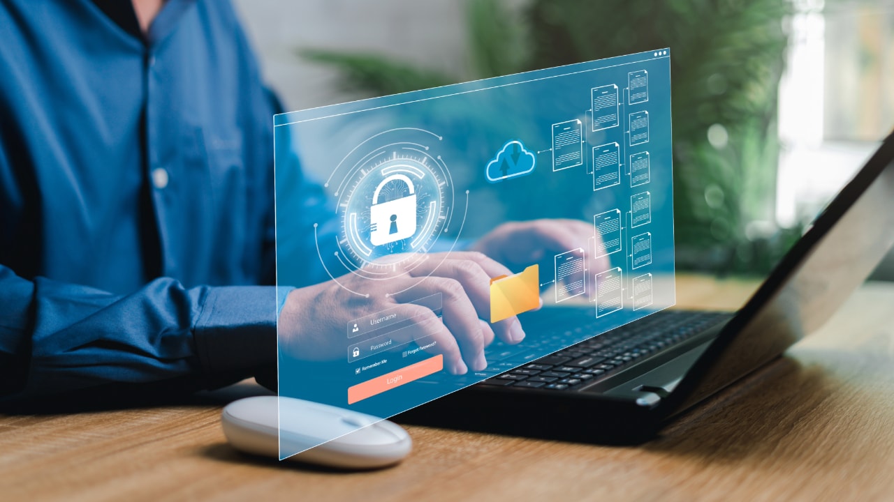 person on laptop encrypting sensitive data and information for data protection 