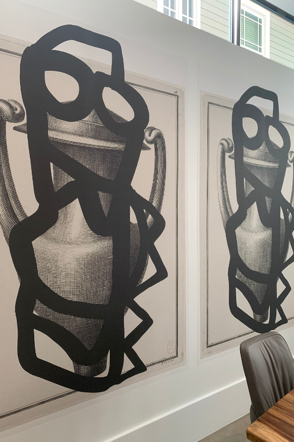 two large black and white prints that are vaguely human-shaped
