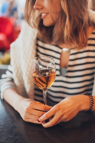 Woman with a passion for wine enjoying the ambiance at the Lounge