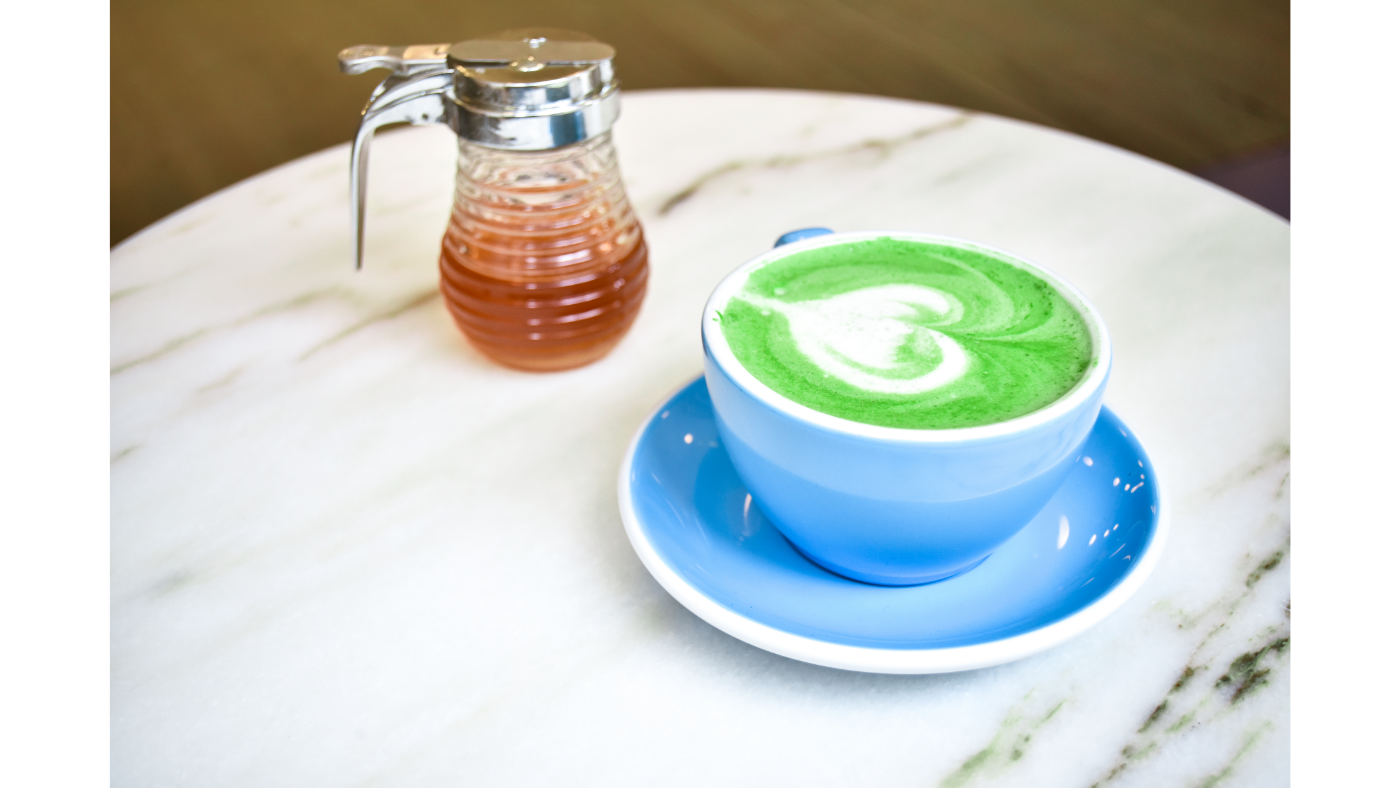A cup of matcha green tea latte with honey, stevia and maple syrup