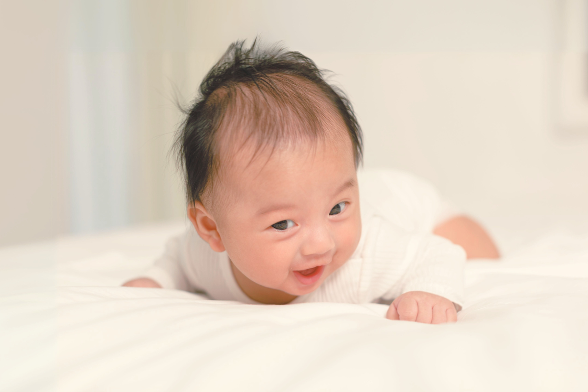 Baby doing tummy time. Poppyseed Play