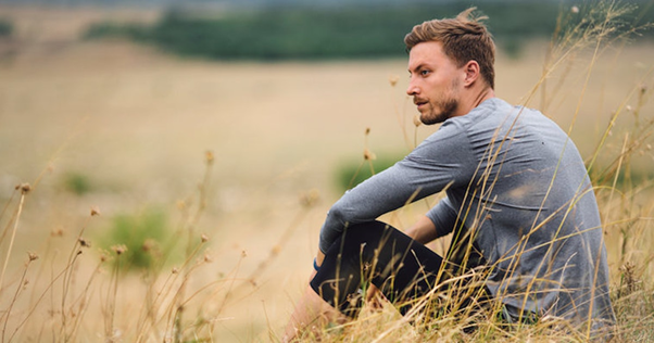 A guy sitting alone in nature https://www.elitedaily.com/dating/guy-never-been-in-relationship/1388437