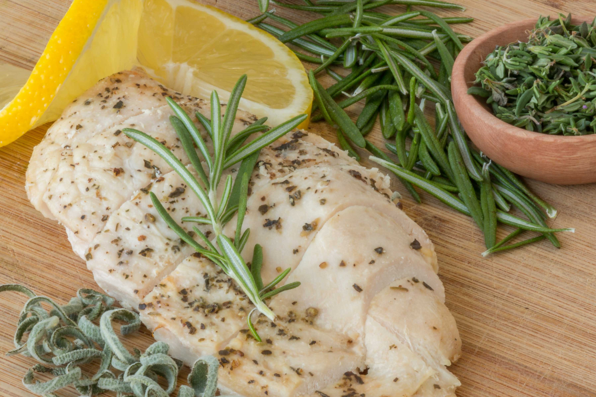 preparing chicken with mild seasonings and herbs and olive oil